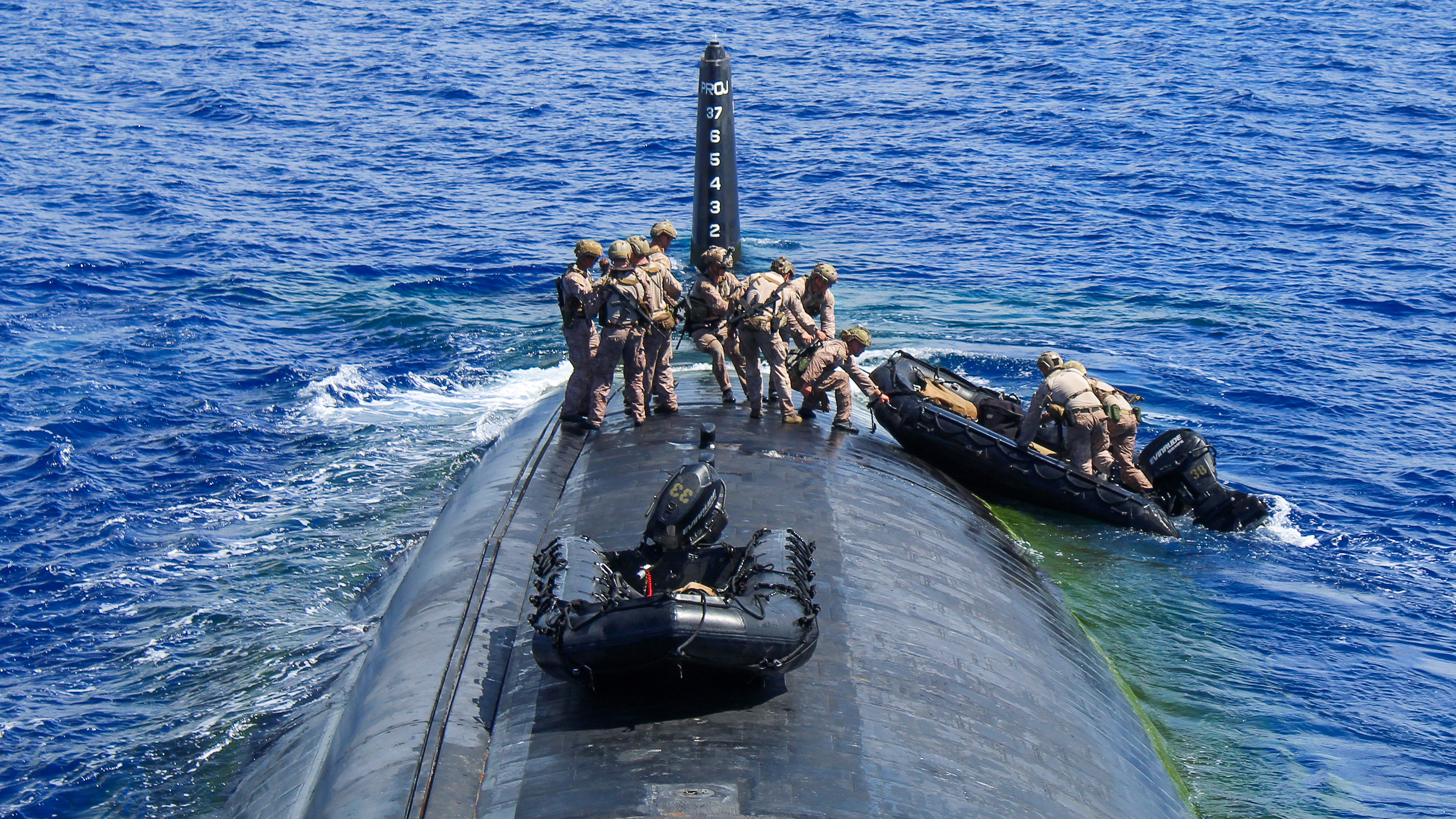U.S. Marines from 3d Reconnaissance Battalion, III Marine Expeditionary Force (MEF), depart the Los Angeles-class fast-attack submarine USS Alexandria (SSN 757) on a combat rubber raiding craft during an integration exercise near Guam, Nov. 12. Credit: U.S. Navy photo by Electronics Technician Navigation 3rd Class Jeoffrey Gamson