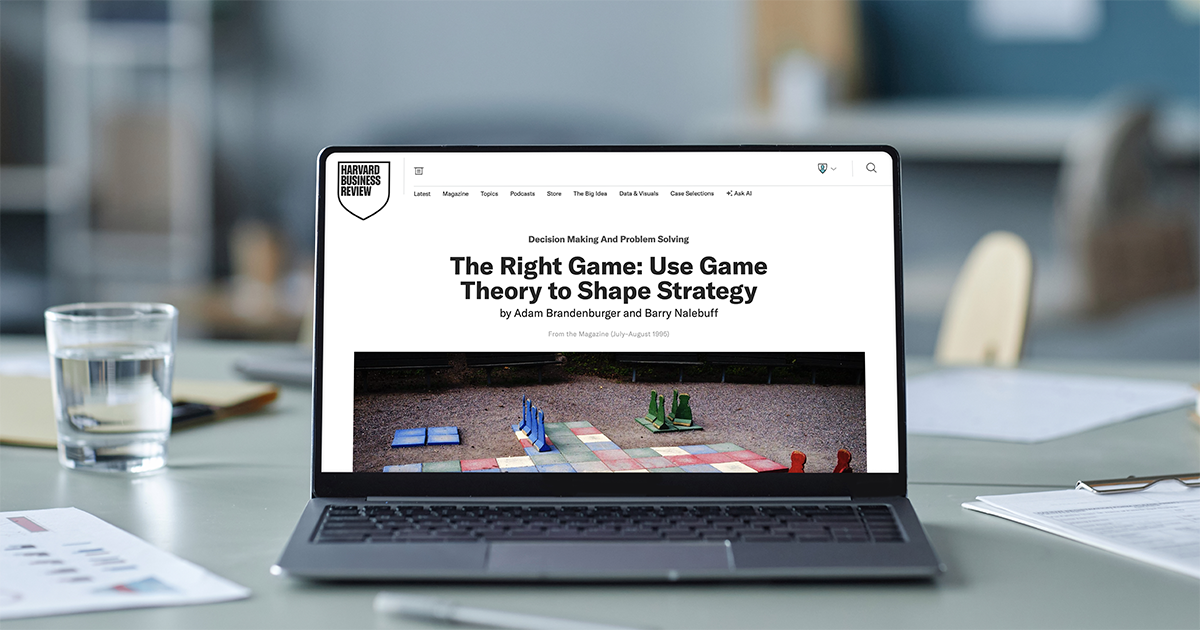 A laptop displaying the HBR article The Right Game: Use Game Theory to Shape Strategy.
