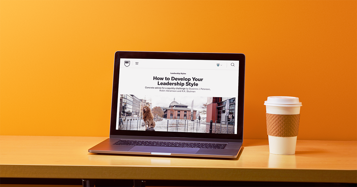 A laptop displaying the HBR article How to Develop Your Leadership Style.