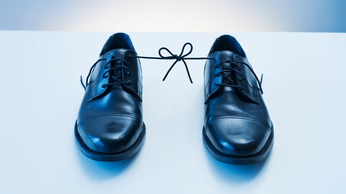 Photo of 2 shoes with their laces tied together.
