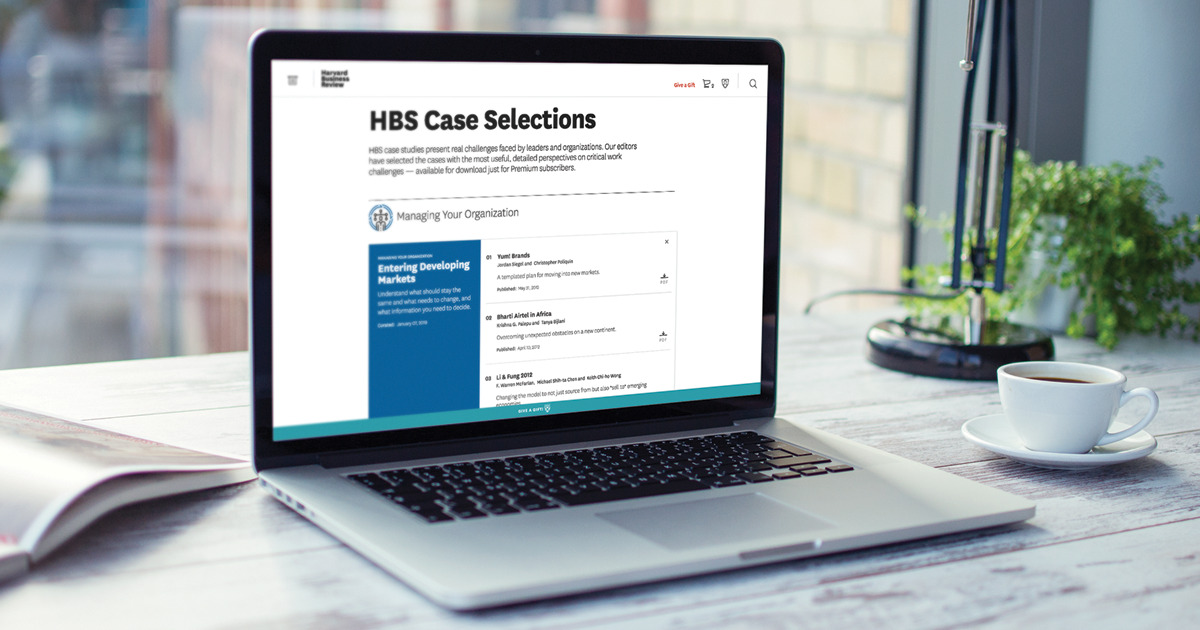 Laptop showing HBS Case Selections from Harvard Business School, featuring case studies on managing organizations and entering developing markets.
