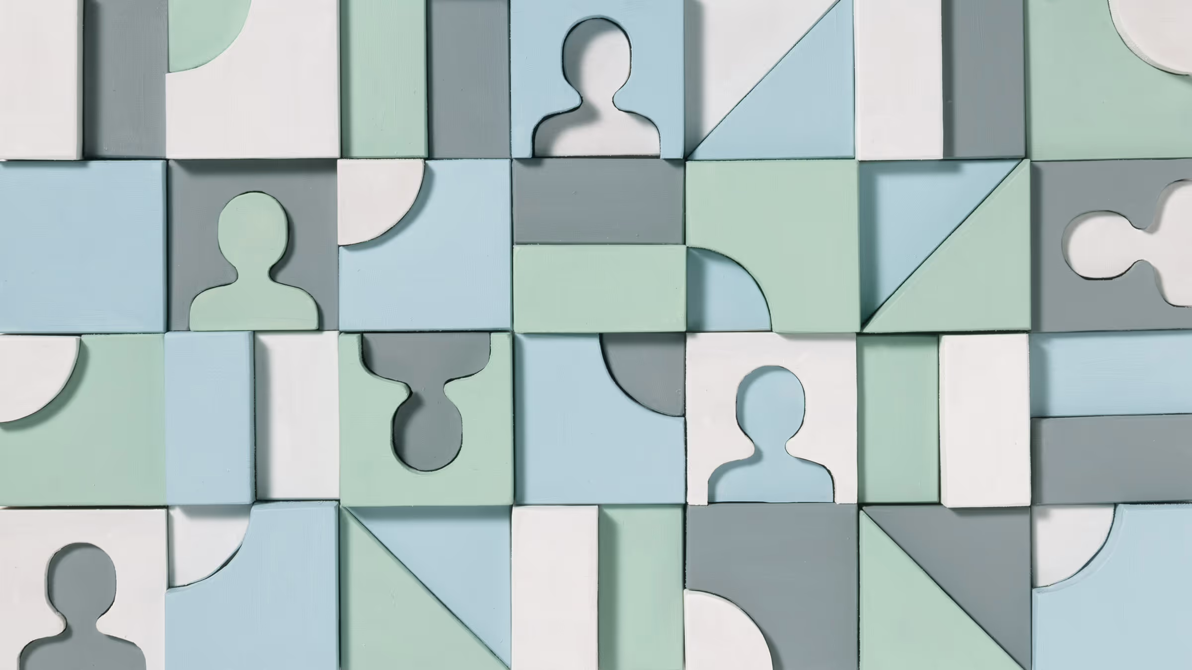 Abstract pattern of interconnected geometric blocks with cutout person icons in soft blue, green, gray, and white.
