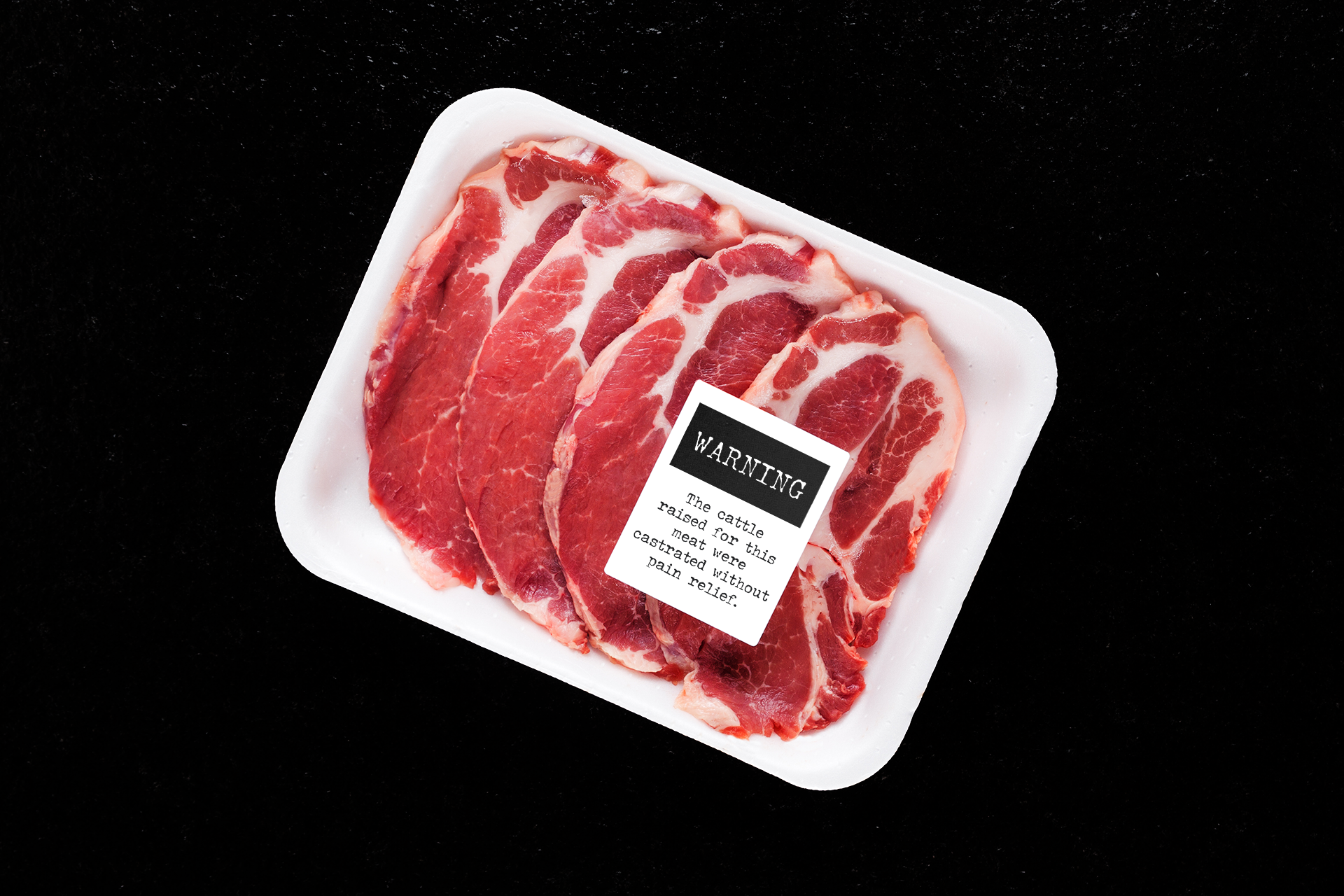 A package of shrink-wrapped meat with a label that reads Warning: The cattle raised for this meat were castrated without pain relief.