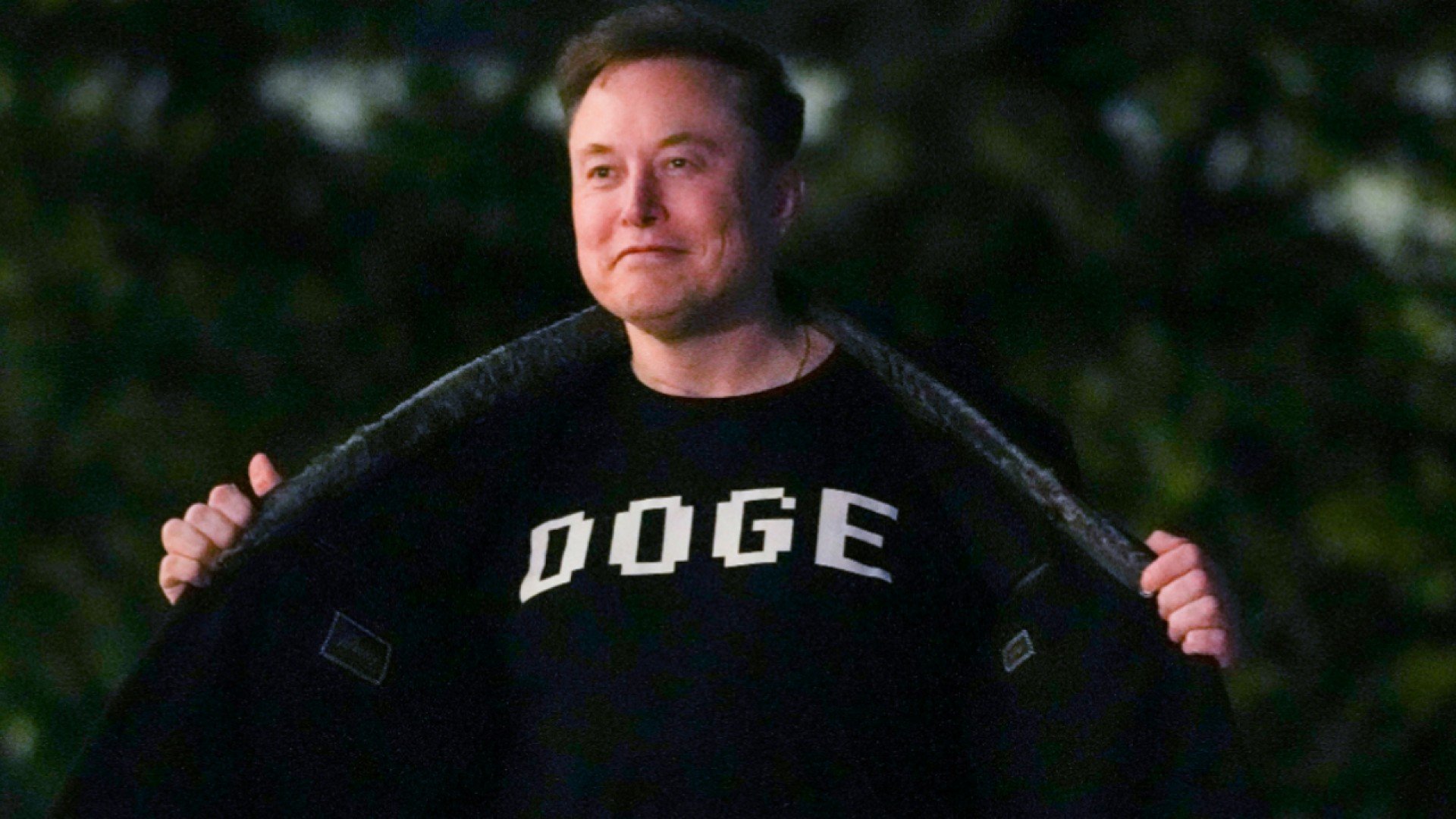 Elon Musk in DOGE shirt.