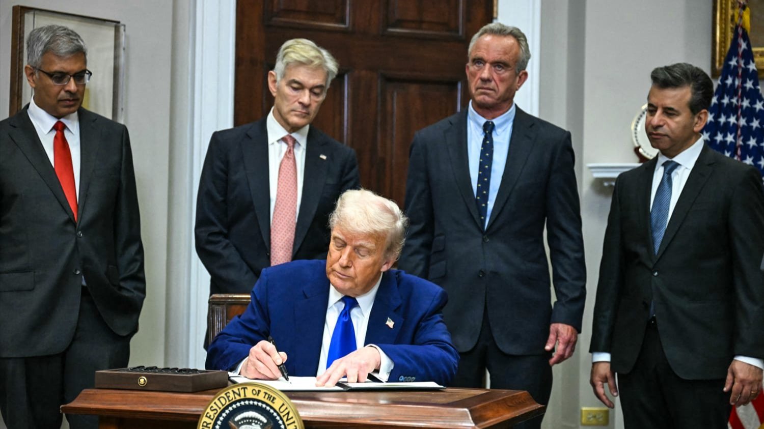 Trump signing an executive order 
