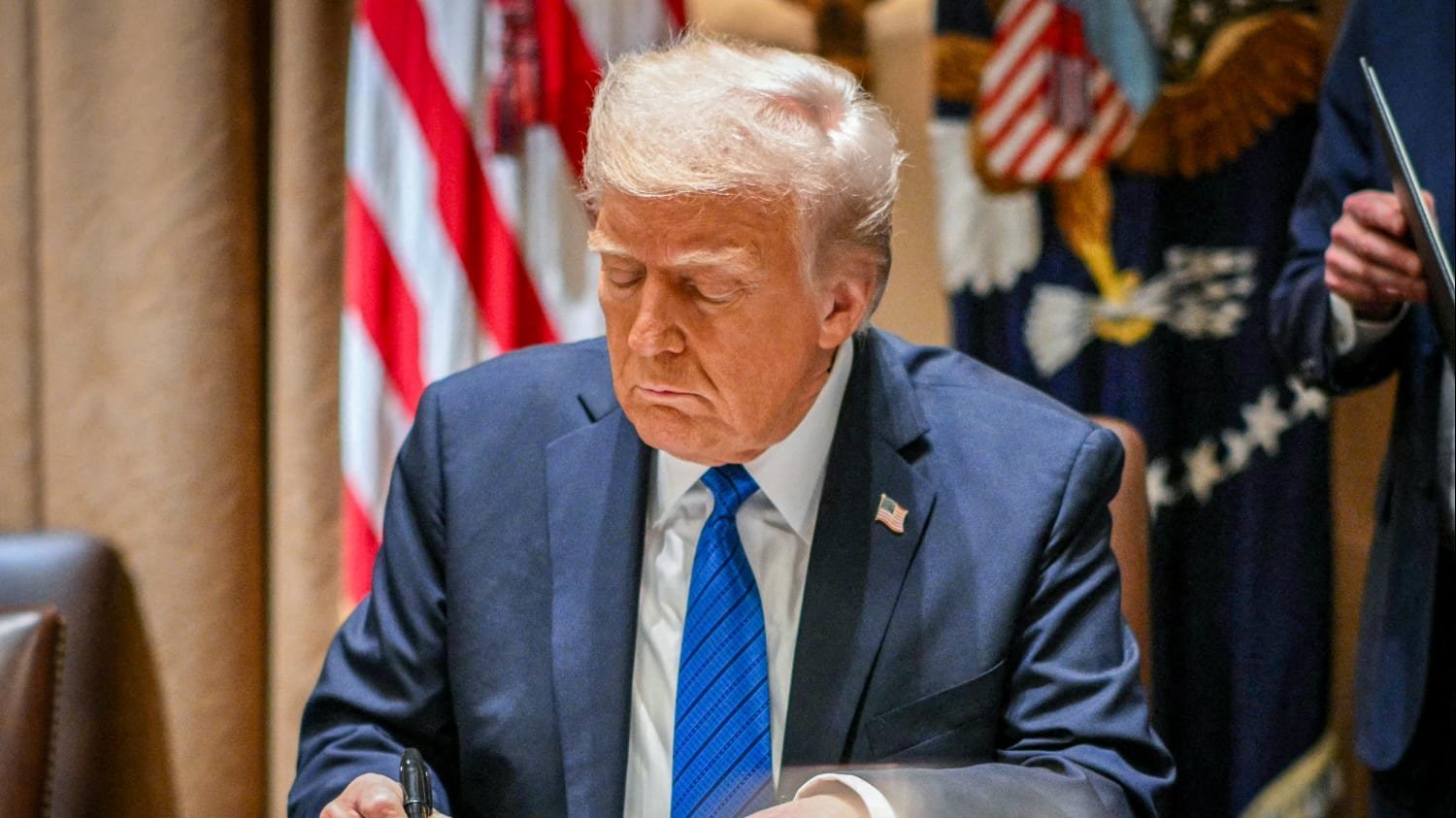 Donald Trump signs executive order.
