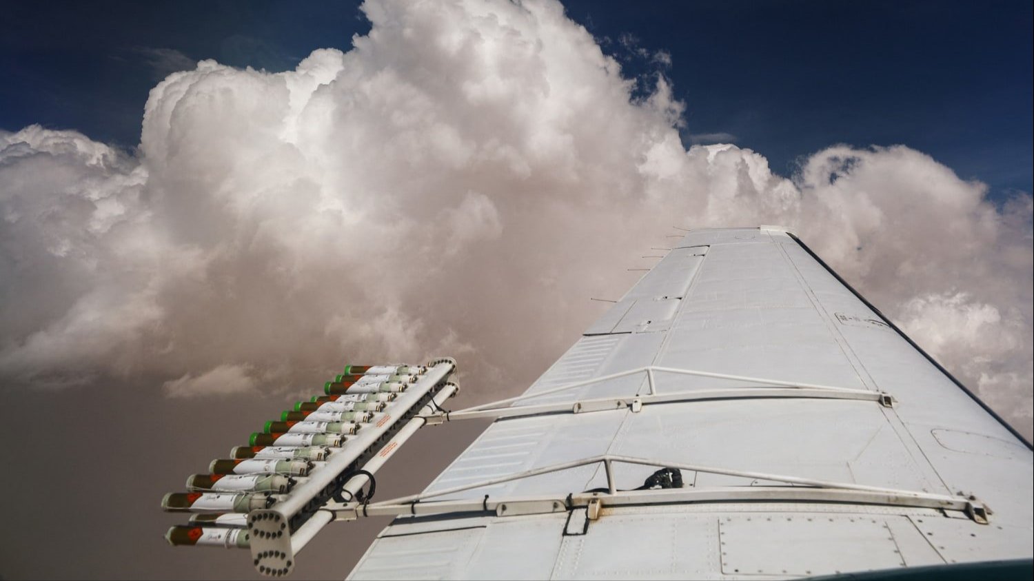 Hygroscopic flares are attached to an aircraft during a cloud seeding flight in United Arab Emirates in 2022