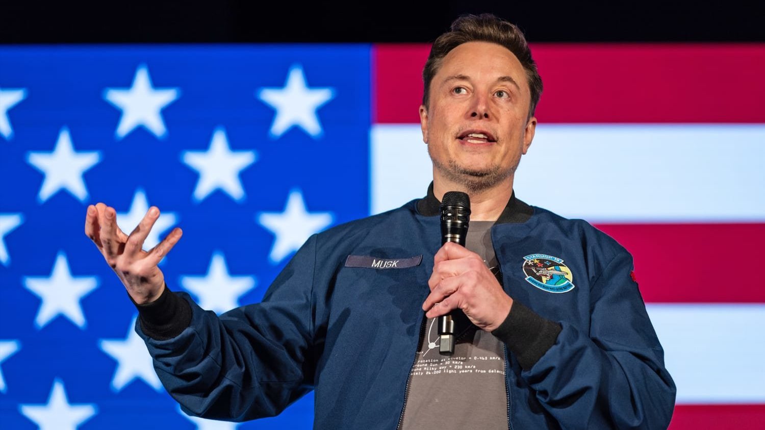 Elon Musk with microphone. 