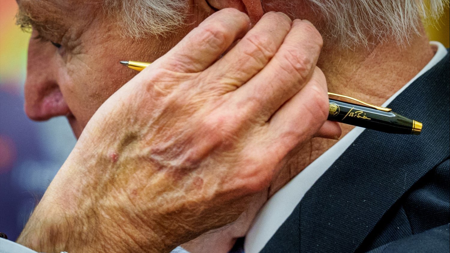 Former President Biden holding a pen