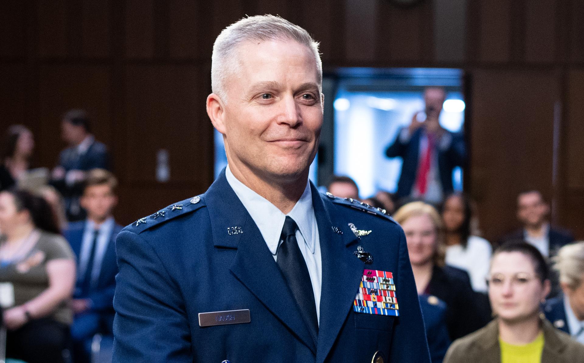 Gen. Timothy D. Haugh extending a hand to shake