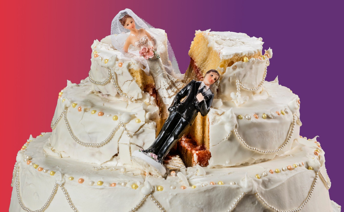 Bride and groom cake toppers on a destroyed wedding cake