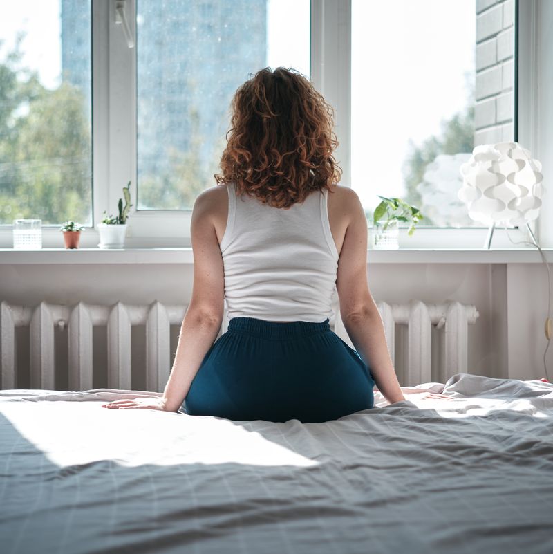 woman sitting on bed 