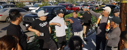 People gather outside after Border Patrol raided the The Home Depot at 1675 Wilshire Blvd. in Los Angeles, CA.