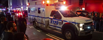 An ambulance rolling along a city street