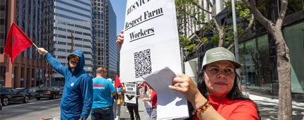 A woman holding up a sign during a rally