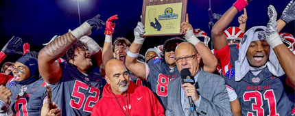 Mater Dei coach Raul Lara receives the 2024 Southern Section Division 1 championship plaque after defeating St. John Bosco.