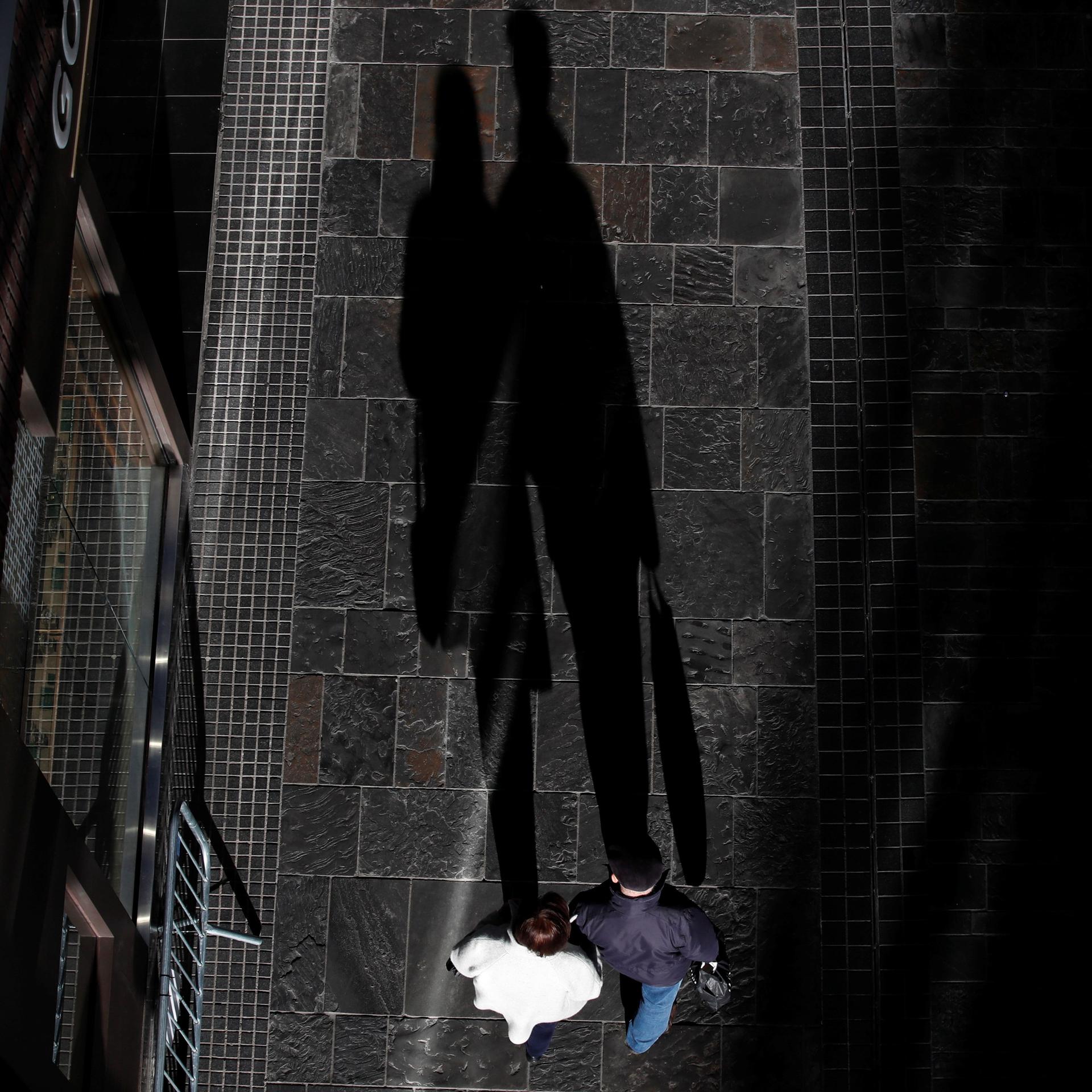 Shadows of shoppers are seen, after new nationwide restrictions were announced during the COVID-19 outbreak, in Bristol, England, on November 4, 2020