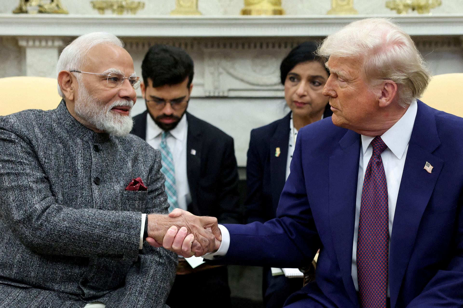 U.S. President Donald Trump and Indian Prime Minister Narendra Modi shake hands sitting in the Oval Office at the White House.