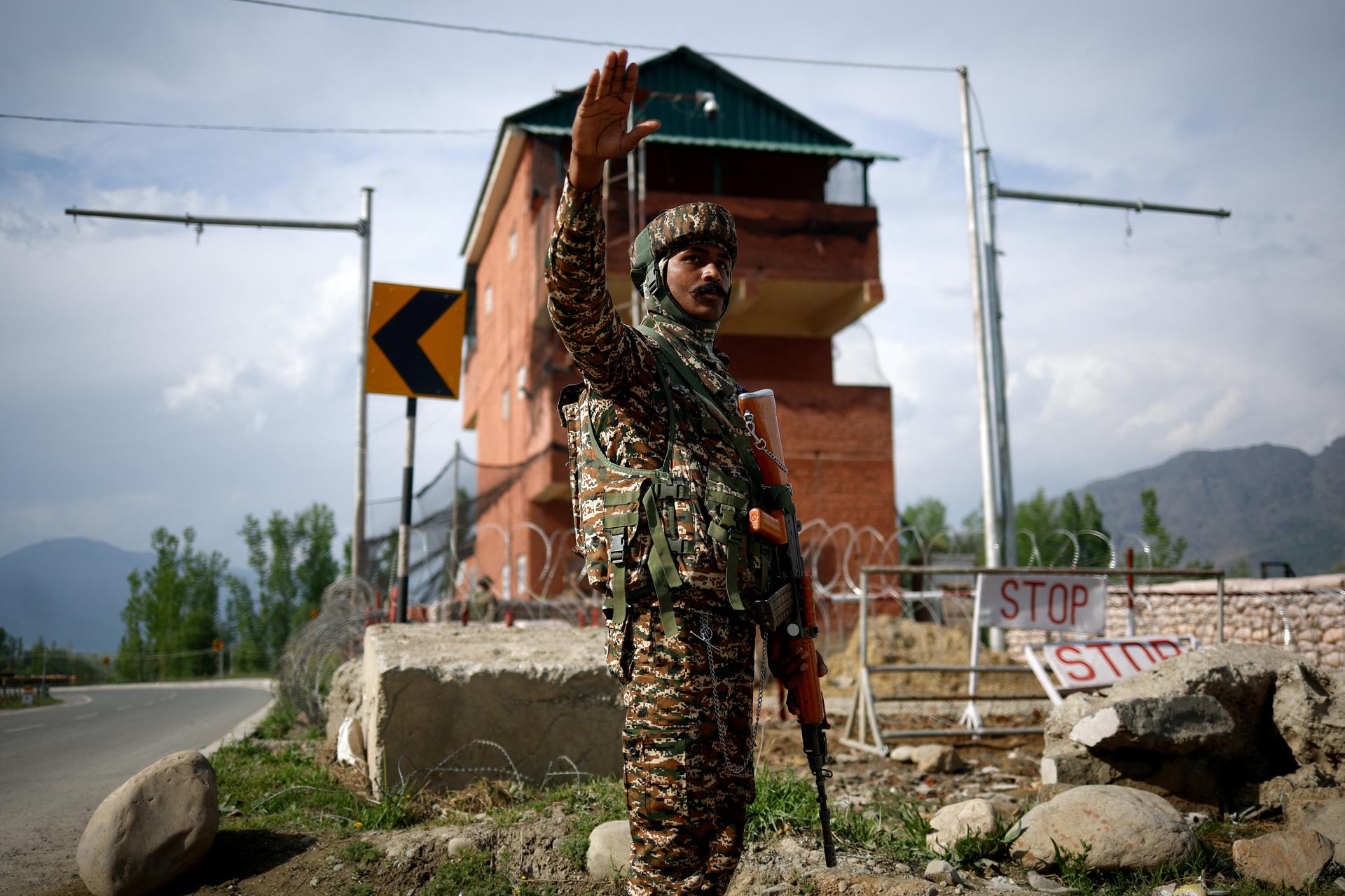 A member of Indian security personnel stands guard on a highway leading to South Kashmir's Pahalgam, following a suspected militant attack in Marhama village, on April 23, 2025.