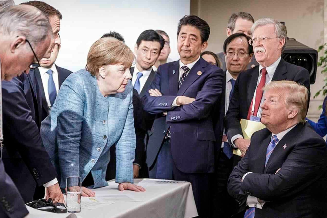 German Chancellor Angela Merkel deliberates with U.S. President Donald Trump on the sidelines of the G7 summit on June 9, 2018.