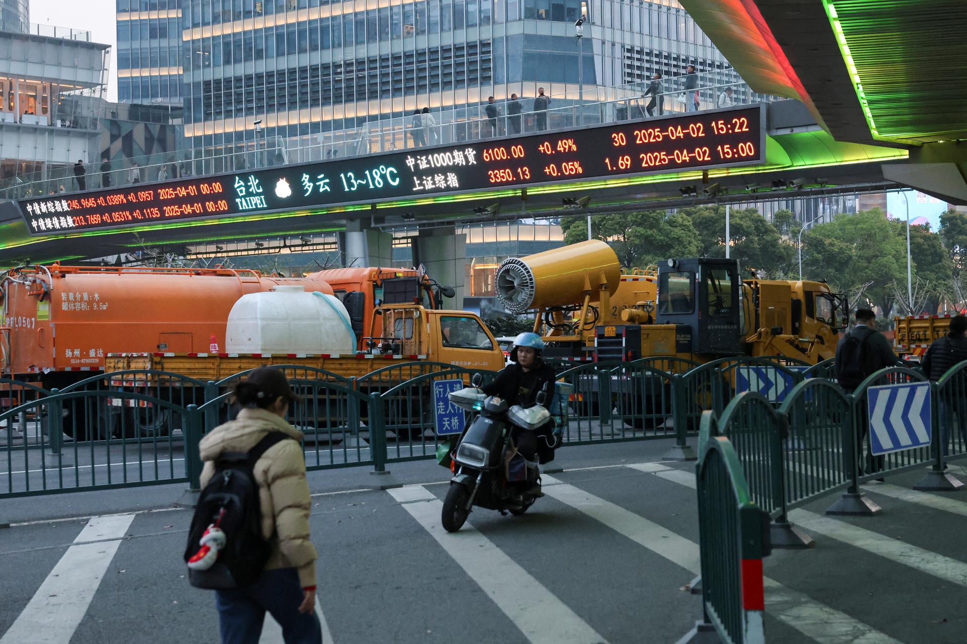 An electronic board shows stock indices at the Lujiazui financial district in Shanghai, China April 2, 2025.