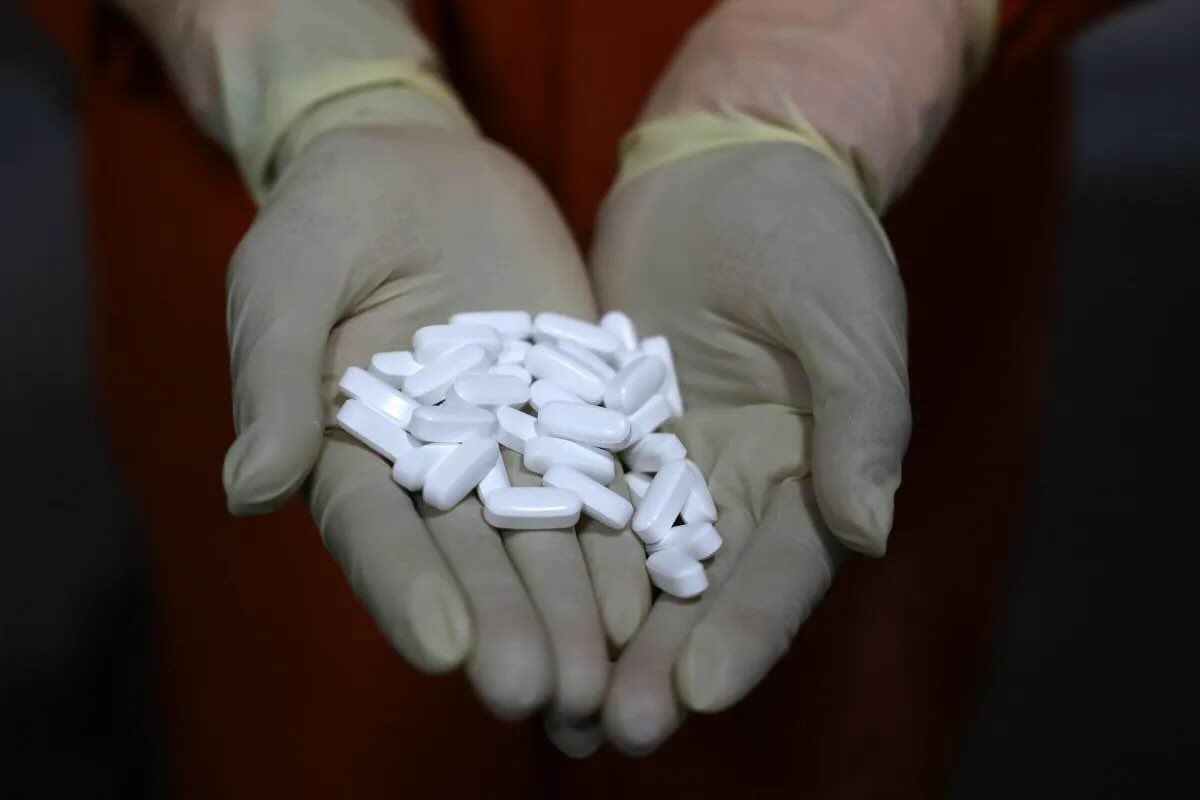 An employee checks coated tablets at a manufacturing plant in Ahmedabad, India, April 2025