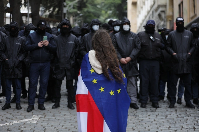 A pro-European Union protester stands outside the security perimeter of the Georgian Parliament. Mirian Meladze/Anadolu/Getty Images
