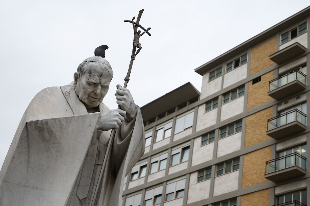 A bird is seen on the statue of the late Pope John Paul II, outside the Gemelli Hospital, where Pope Francis is admitted to continue treatment for his ongoing respiratory tract infection, in Rome, Italy, February 19, 2025. (Guglielmo Mangiapane/Reuters)
