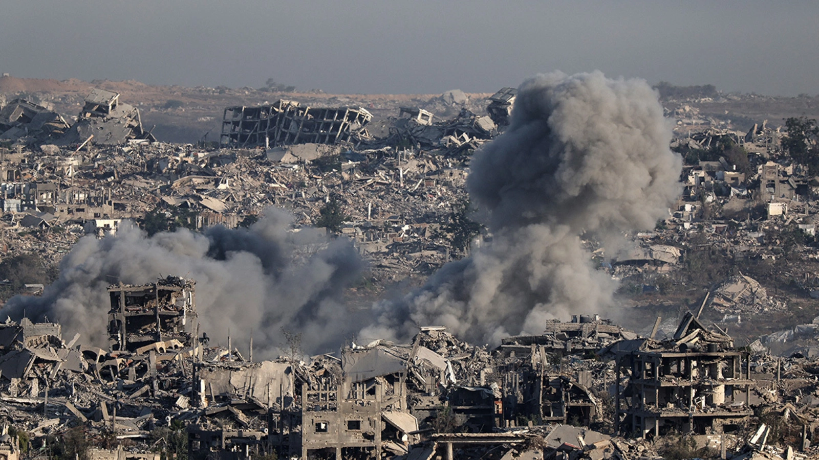 Smoke billows over destroyed buildings in Gaza during an Israeli strike, July 17, 2025.