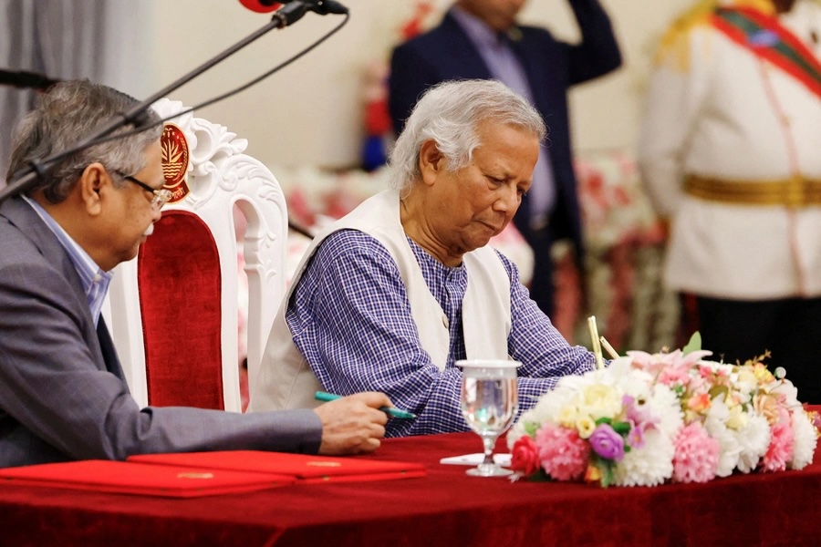 Nobel laureate Muhammad Yunus signs the oath book as the country’s head of the interim government in Bangladesh at the Bangabhaban in Dhaka on August 8, 2024. 