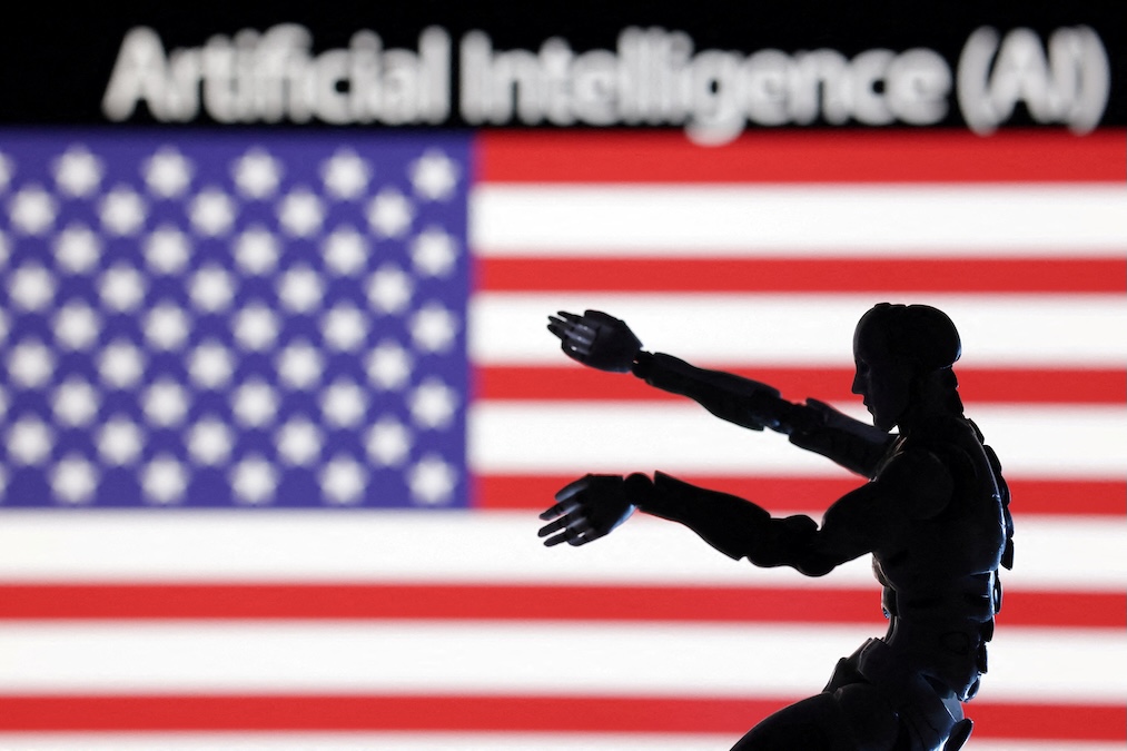 Artificial Intelligence words, miniature of robot and U.S. flag are seen in this illustration taken December 21, 2023. (Dado Ruvic/Reuters)