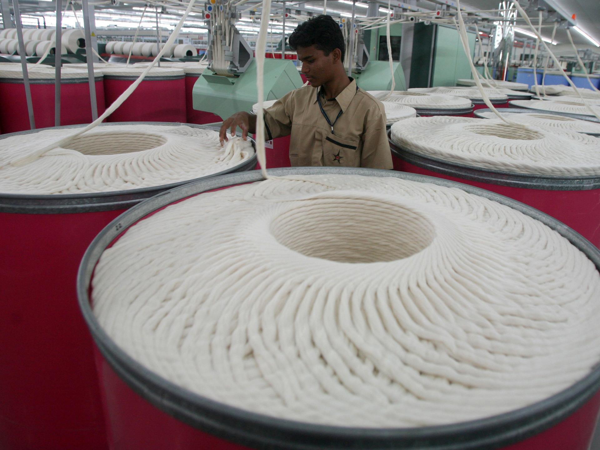 An employee works inside the Century Textiles and Industries Ltd. textile mill, in Gujarat, India, on October 22, 2009. 
