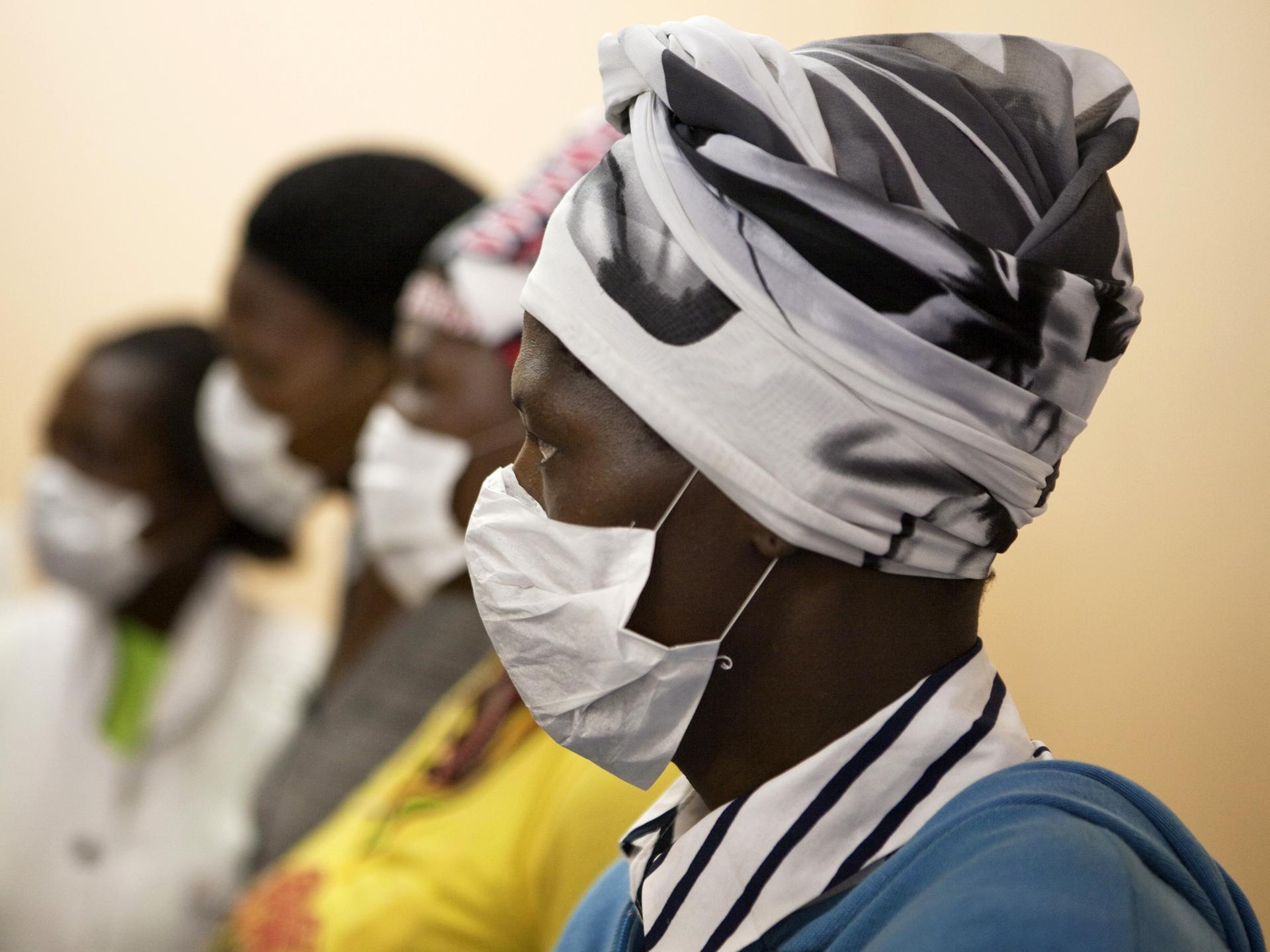 Patients with HIV and tuberculosis (TB) wear masks while awaiting consultation at a clinic in Cape Town, South Africa, on February 23, 2010. 