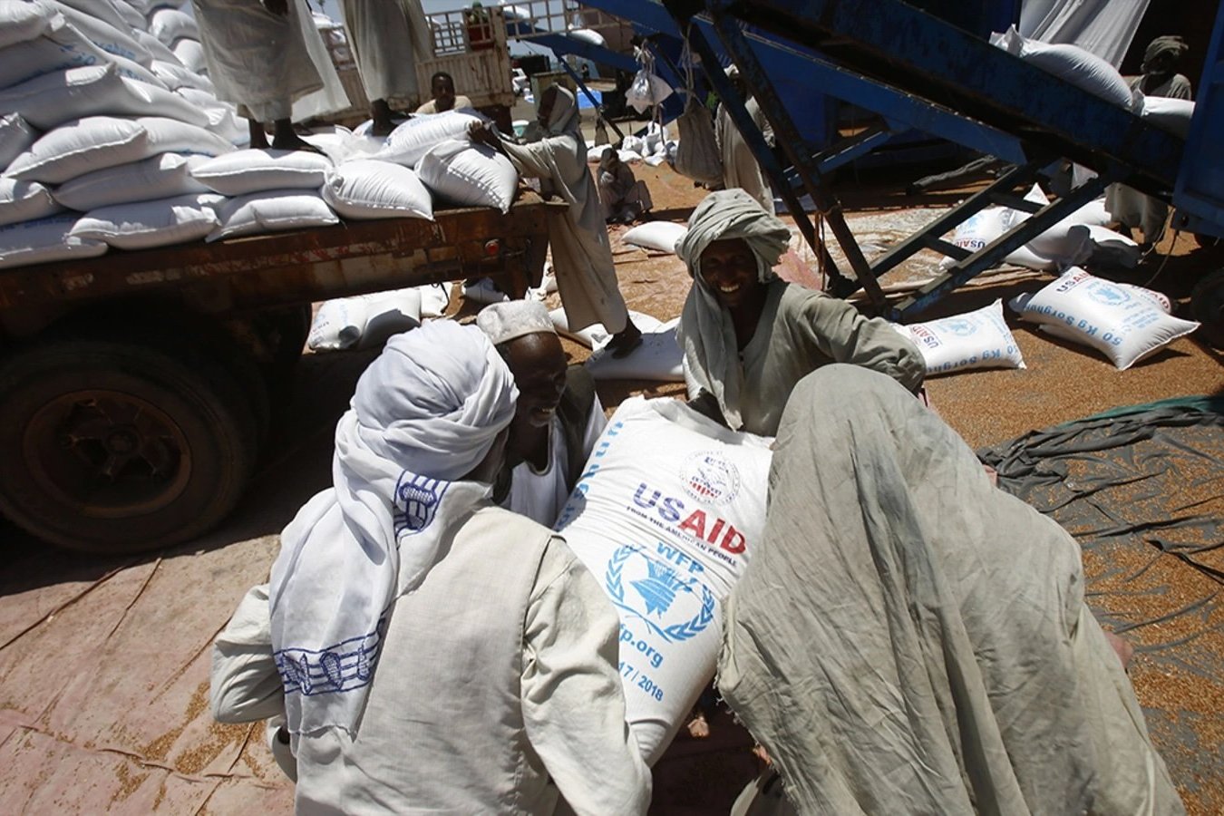 Sudanese dockers unload bags of cereal from U.S. ships carrying humanitarian aid supplies provided by USAID, at Port Sudan on the Red Sea.