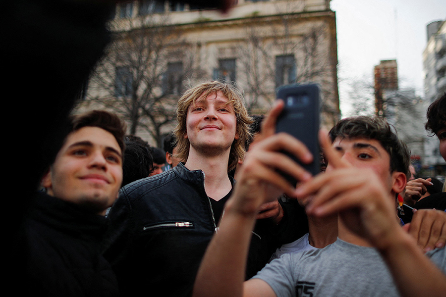Inaki Gutierrez, who manages Argentine presidential candidate Javier Milei's TikTok, poses for a selfie with supporters, after a Milei's campaign rally in La Plata, on the outskirts of Buenos Aires, Argentina September 12, 2023. (Agustin Marcarian/Reuters)