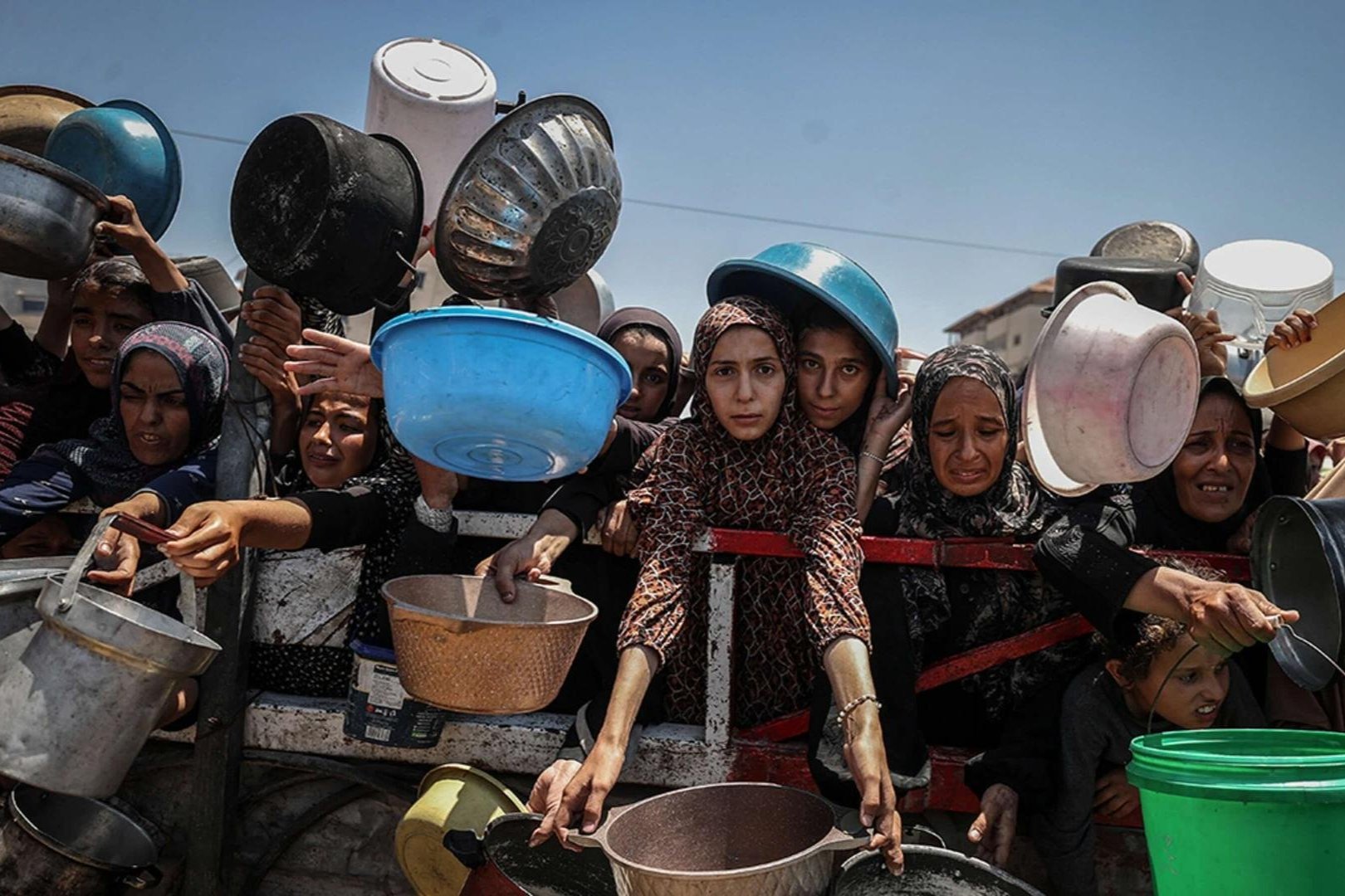 Crowds form in Gaza City as Palestinians line up to receive food distributed by a charity amid an ongoing Israeli blockade. 