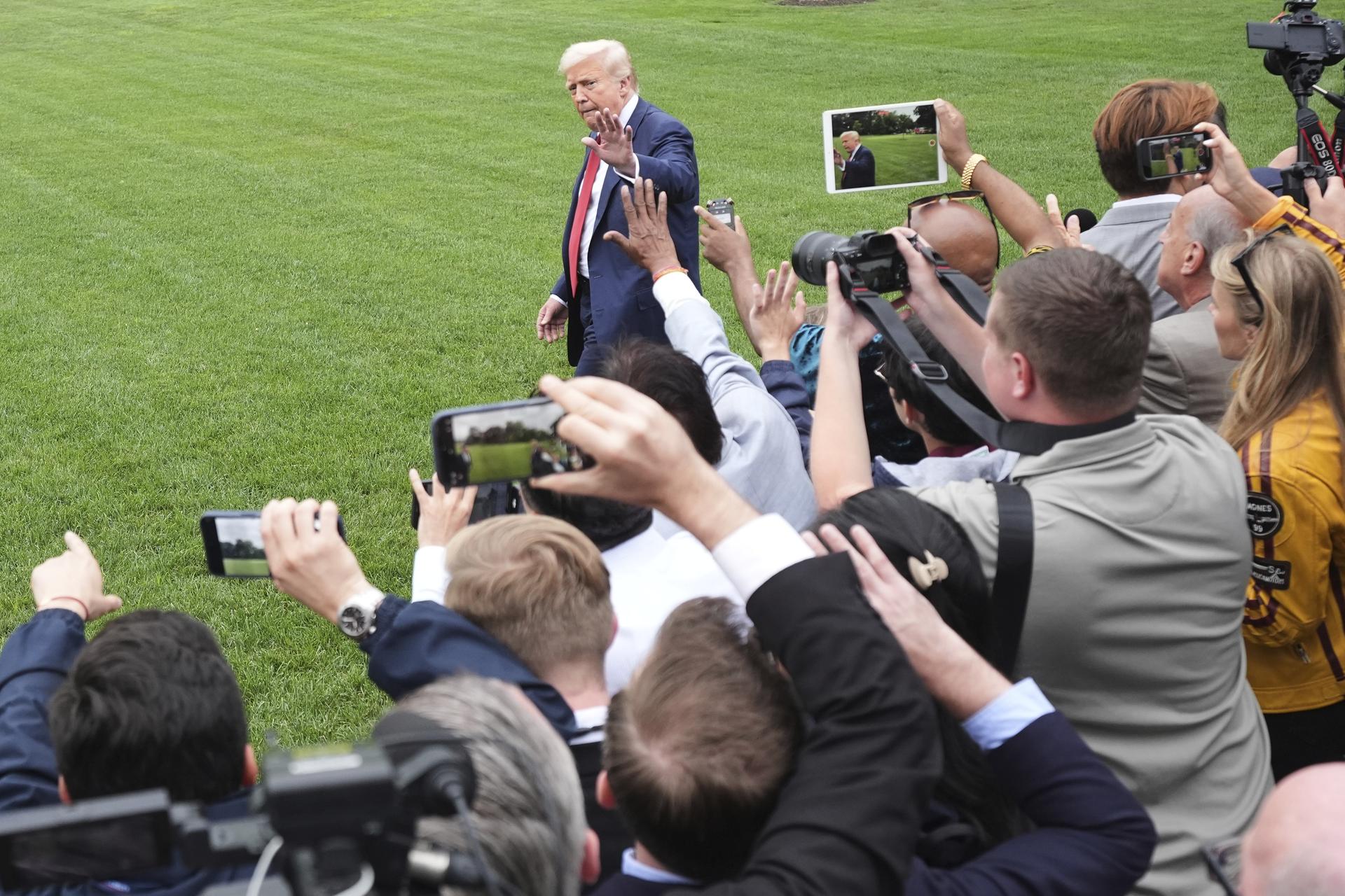 President Donald Trump departs the White House after speaking with reporters, en route to Joint Base Andrews, Md., on Friday in Washington. (AP Photo/Jacquelyn Martin)