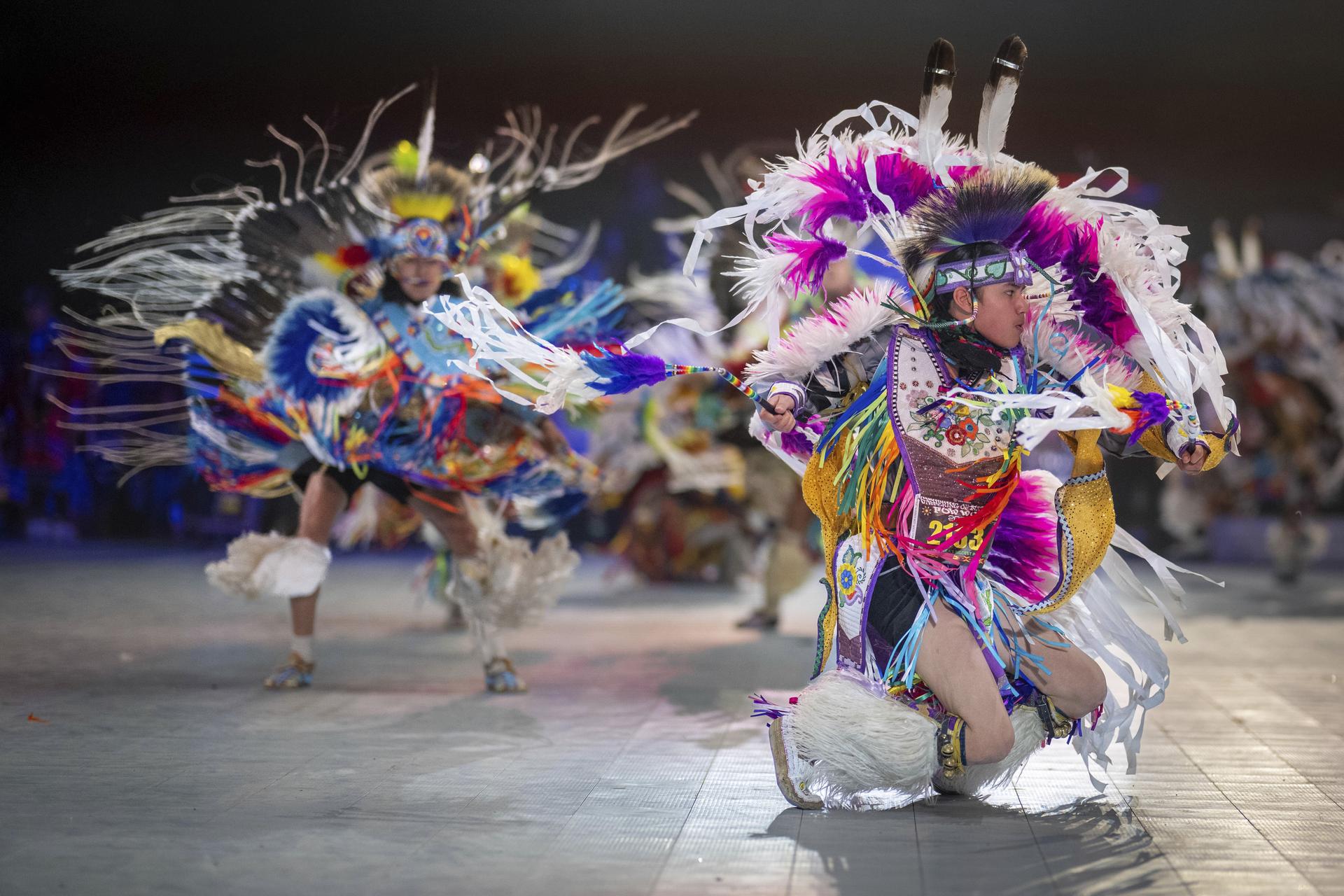 Thirteen year-old Leland Mitsuing, right, of Saskatchewan, Canada competes at the Gathering of Nations Pow Wow in Albuquerque, N.M., April 28, 2023. (AP Photo/Roberto E. Rosales)
