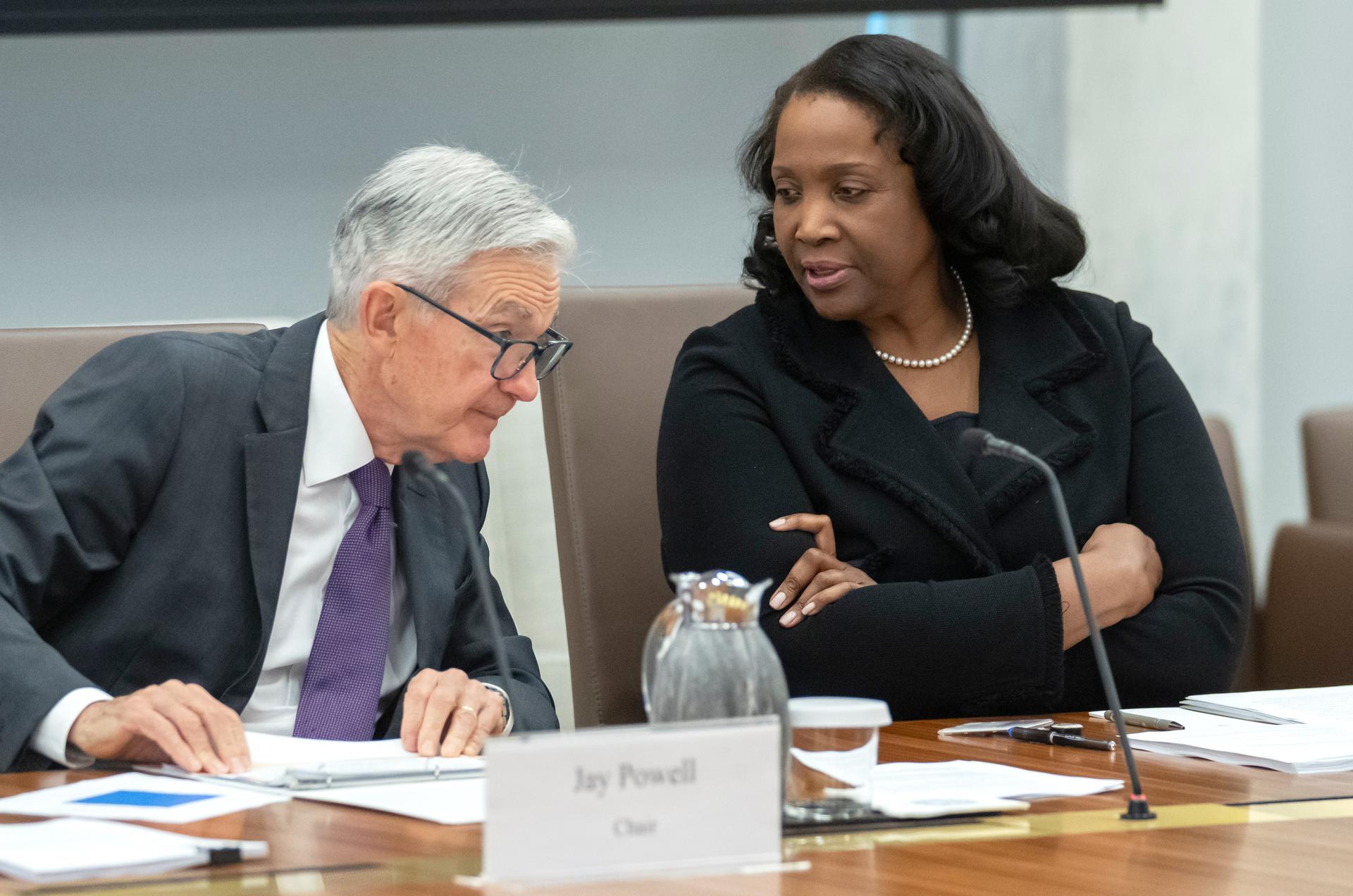 Federal Reserve Board of Governors member Lisa Cook, right, talks with Federal Reserve Chairman Jerome Powell before an open meeting in June. (AP Photo/Mark Schiefelbein)