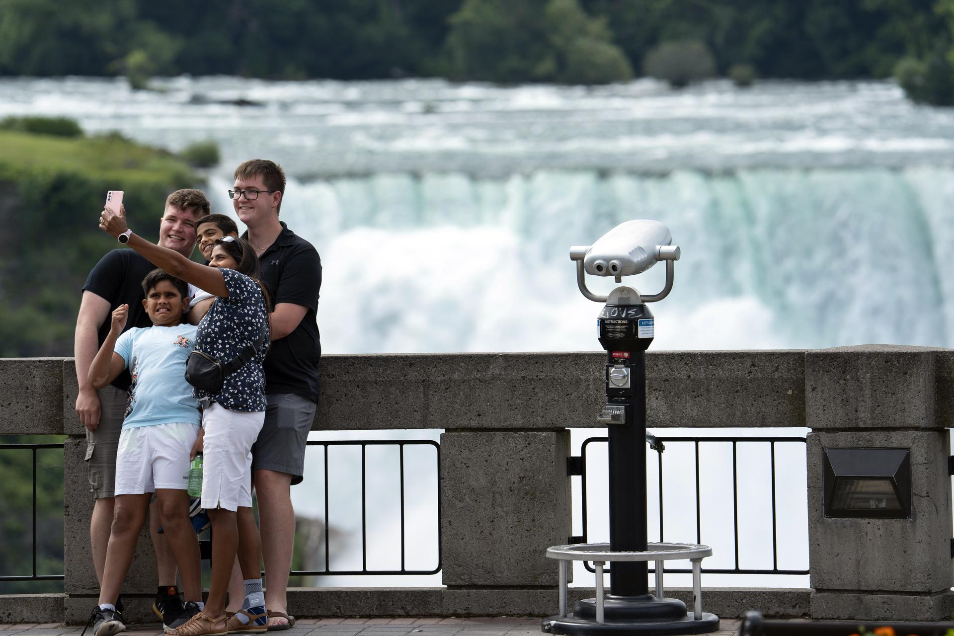 Tourists pose for selfies at Niagara Falls, Ontario, in 2021. 