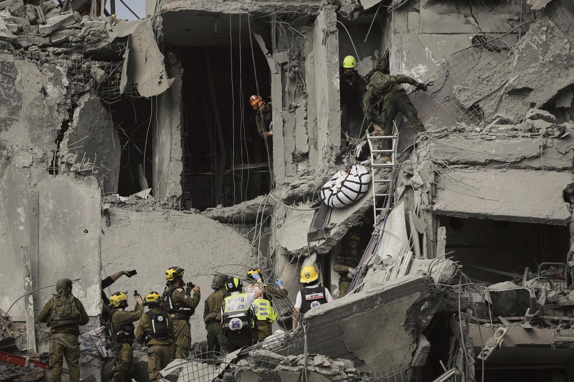 Israeli soldiers work amid the rubble of residential buildings destroyed by an Iranian missile strike in Beersheba, Israel, on Tuesday.