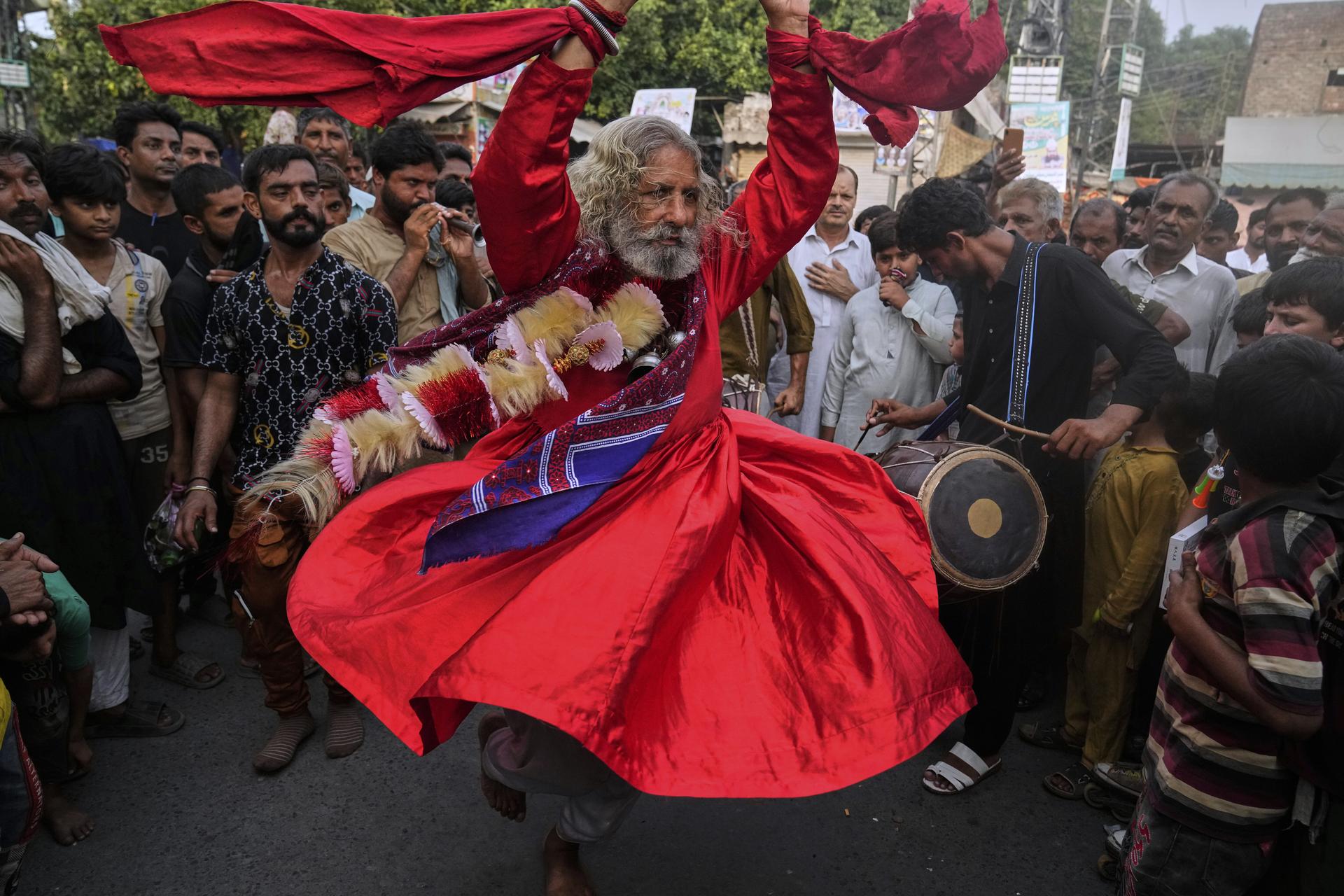 A spiritual path devotee locally called 'Malang' performs traditional Sufi trance dance called 'Dhamaal' on Aug. 13. (AP Photo/K.M. Chaudary)