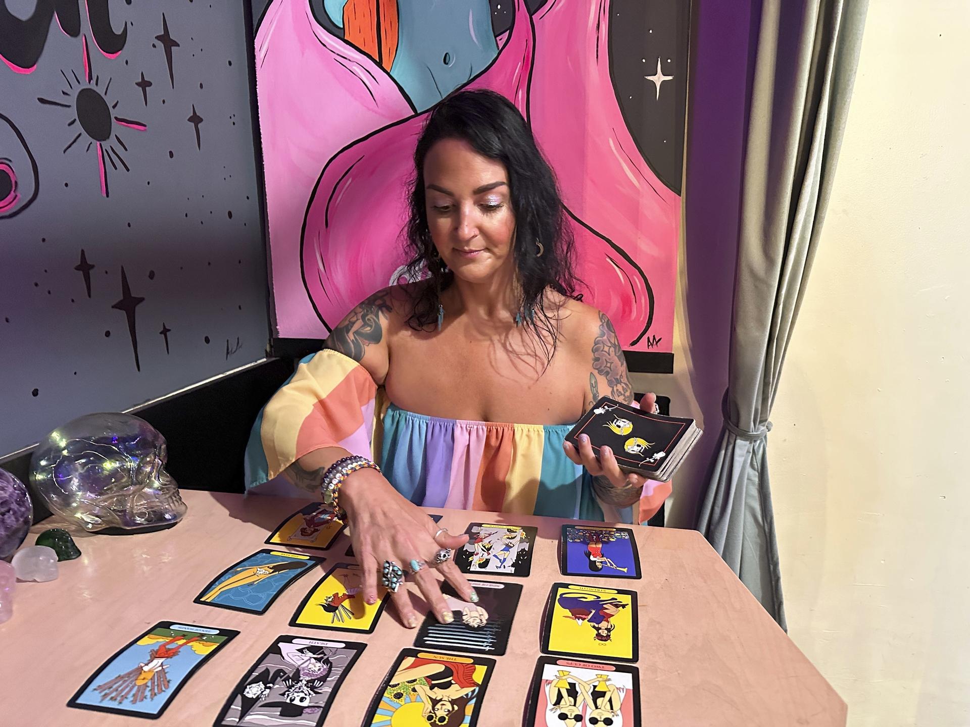 Ashley Branton lays out tarot cards in the back of her shop, Velvet Witch, in Norfolk, Va.