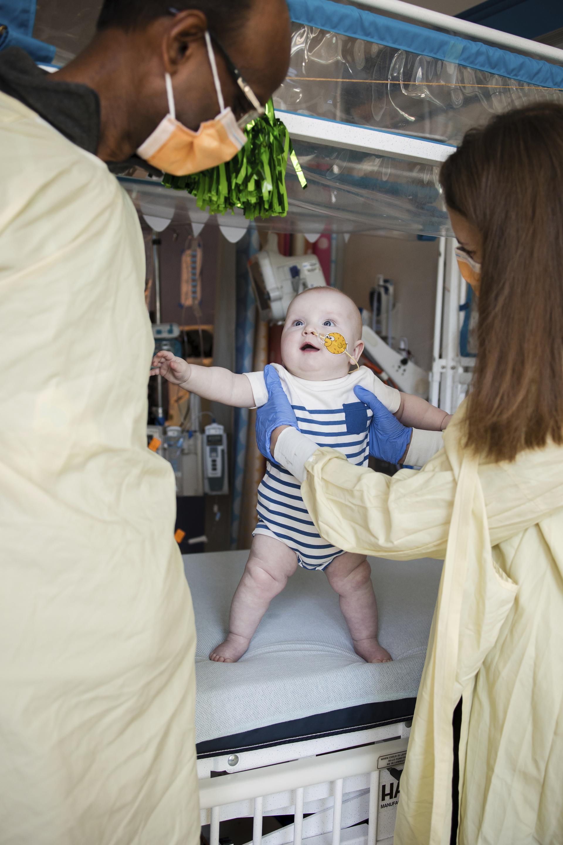 KJ Muldoon is held by doctors after a follow-up dose of an experimental gene editing treatment.