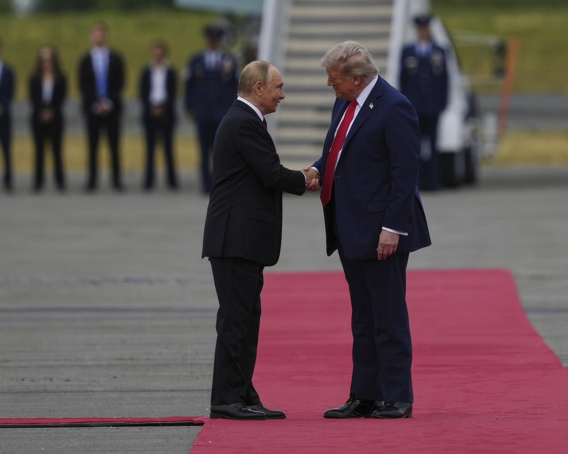 President Donald Trump greets Russia's President Vladimir Putin on Friday at Joint Base Elmendorf-Richardson, Alaska.