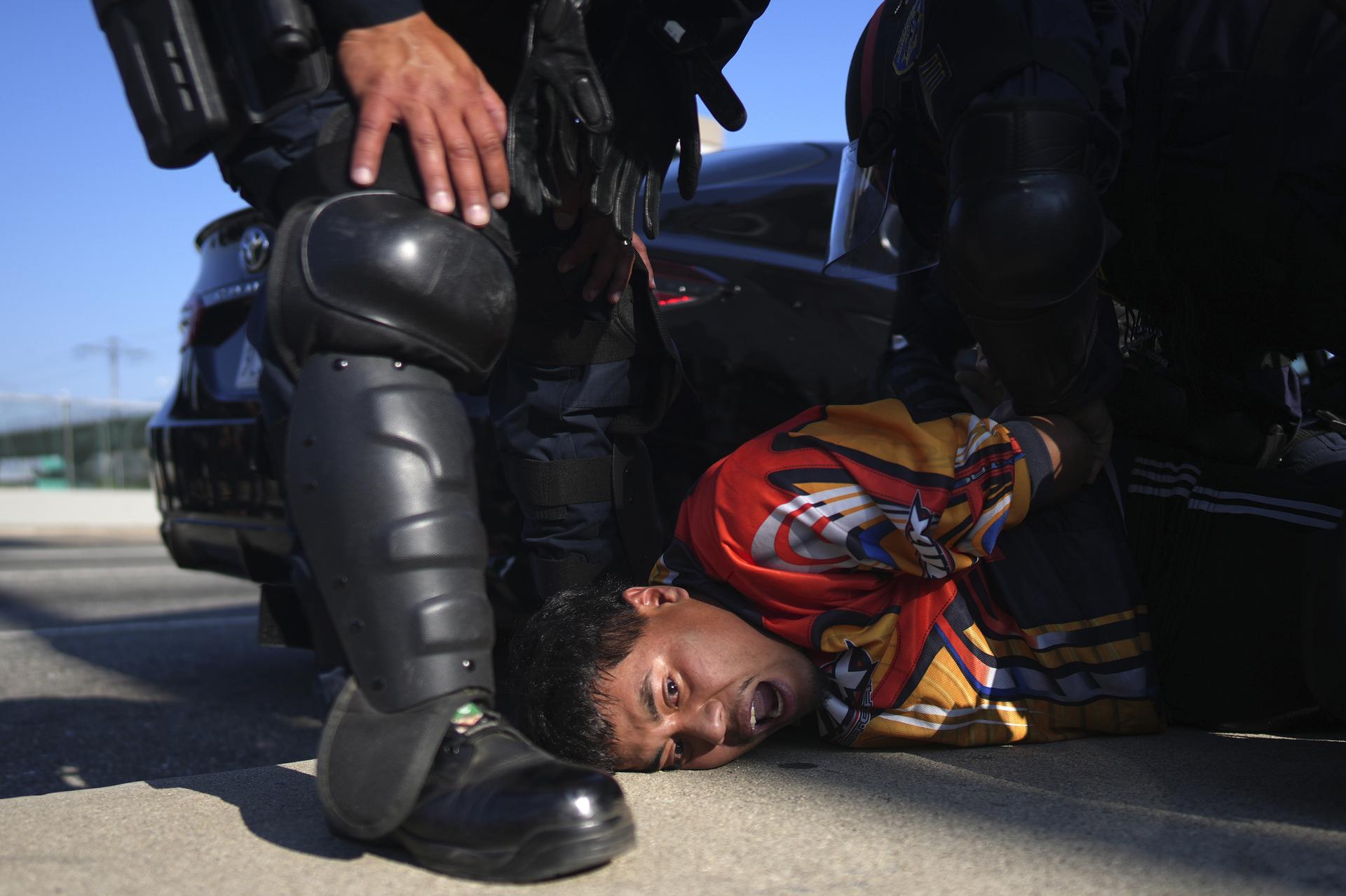 A protester is arrested by California Highway Patrol near the federal building in downtown Los Angeles.