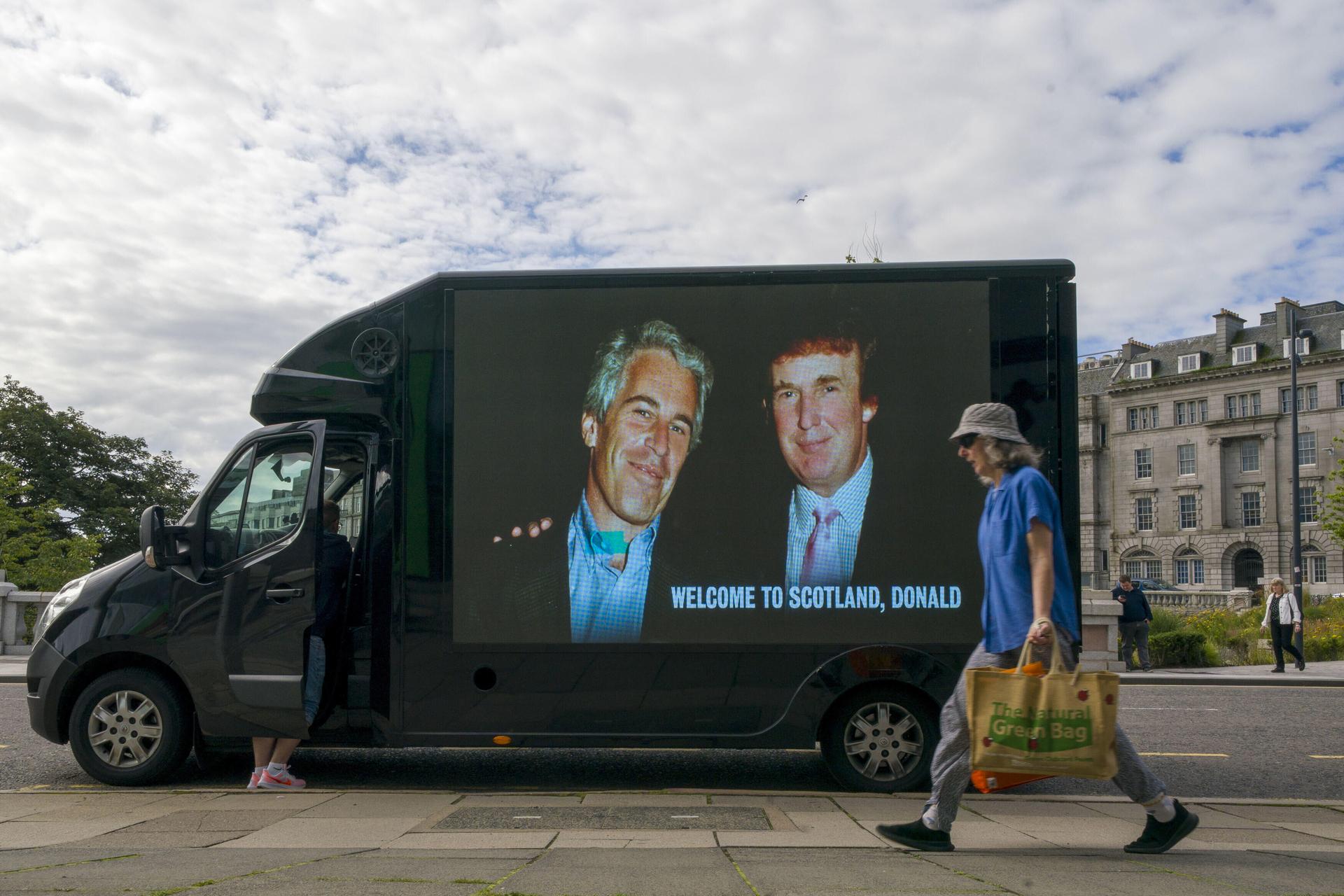 A photograph of US President Donald Trump and Jeffrey Epstein is displayed on the side of a van in Aberdeen during Trump's five-day private trip to Scotland, Monday. 