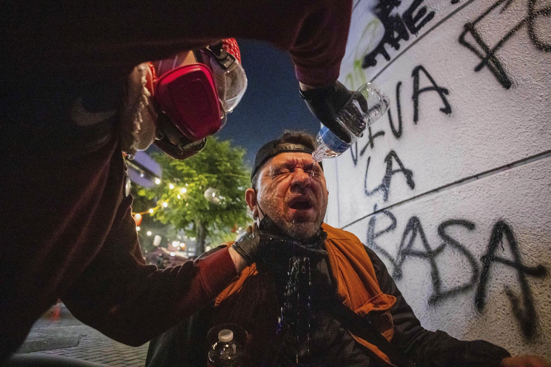 An injured protester is tended to during protests over the Trump administration's immigration raids in Los Angeles on Monday.