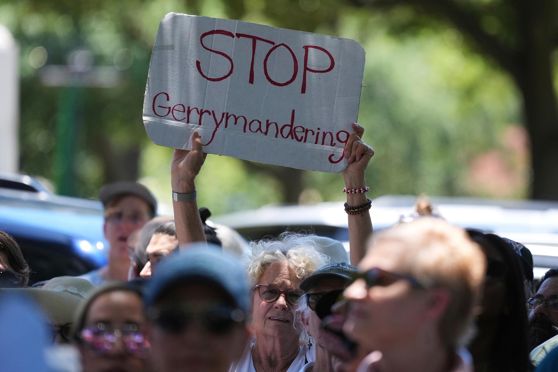 A woman holds a sign during a rally to protest against redistricting hearings at the Texas Capitol on Thursday in Austin, Texas. (AP Photo/Eric Gay)