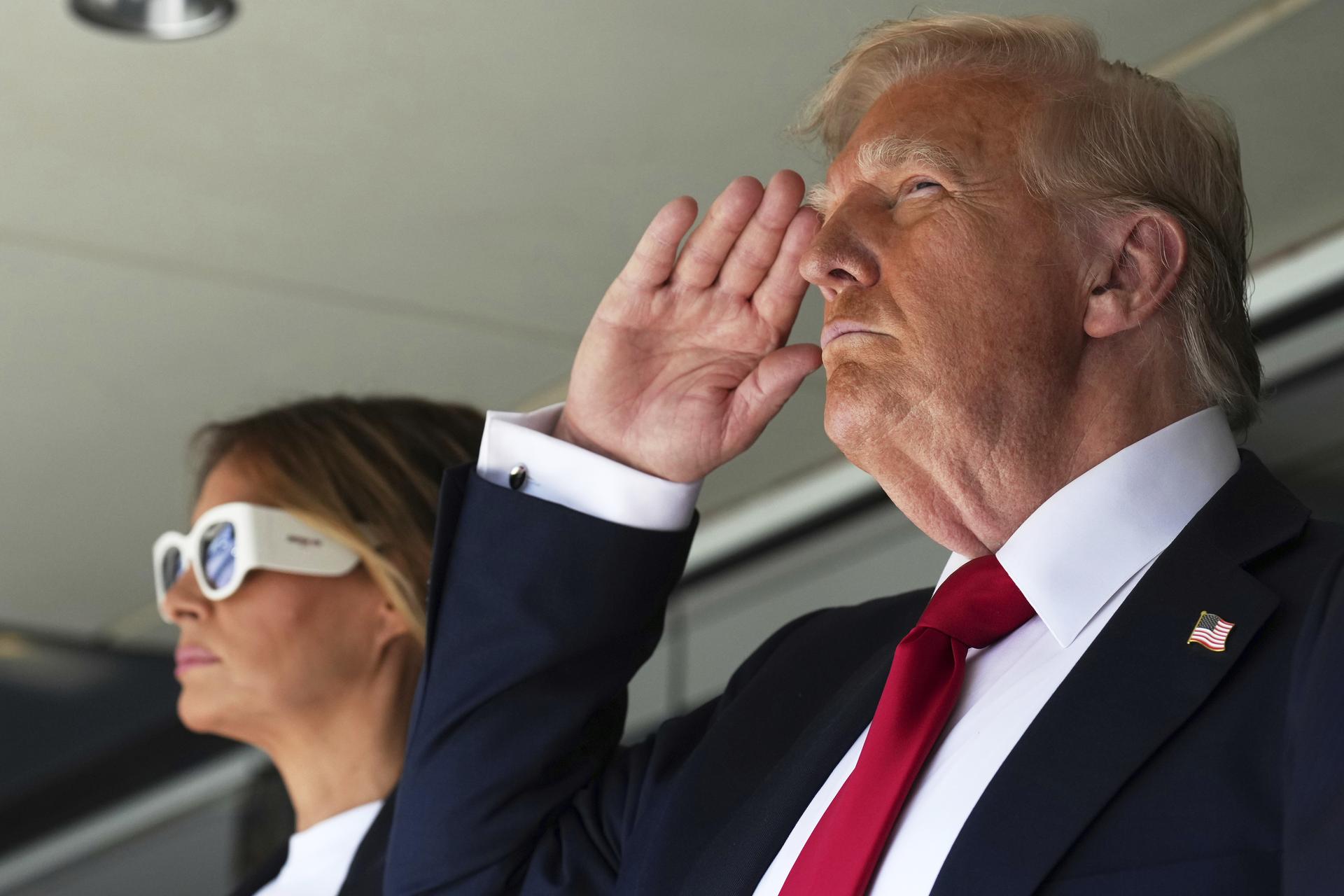 President Donald Trump salutes alongside first lady Melania Trump as they attend the Club World Cup final soccer match, at MetLife Stadium in East Rutherford, N.J., Sunday.